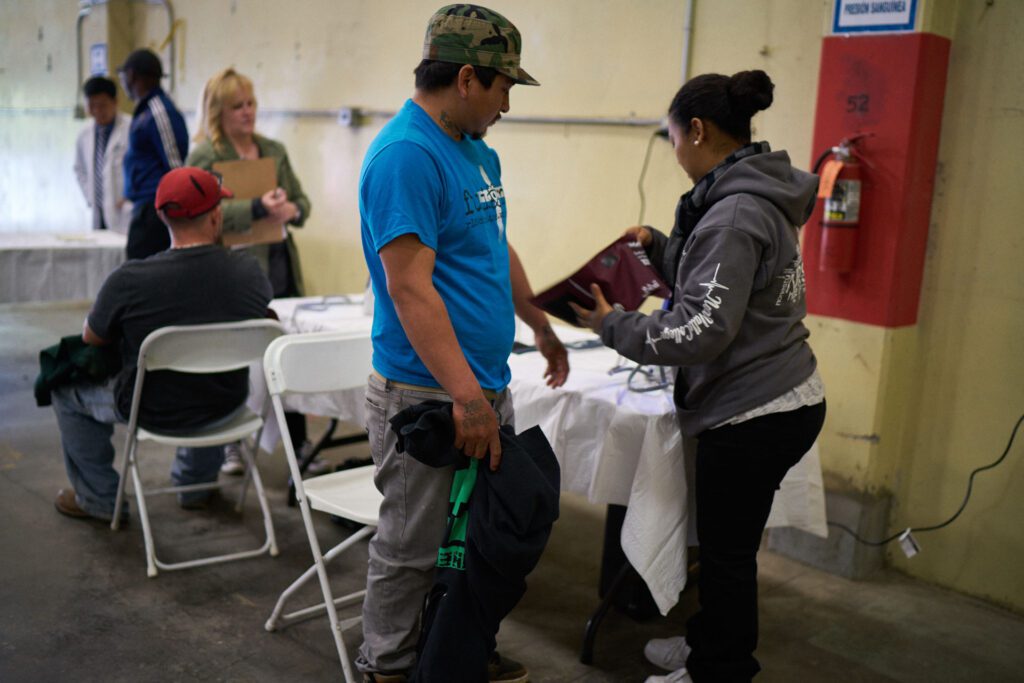A medical professional cares for a farmworker in a rural clinic