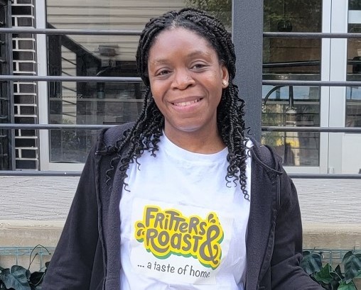 A photo of Black female food entrepreneur smiling at the camera