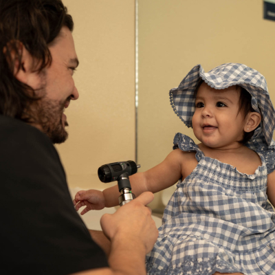 Baby receives affordable health care at a federally qualified health center, Cartmill Clinic, which was financed by Capital Impact Partners.