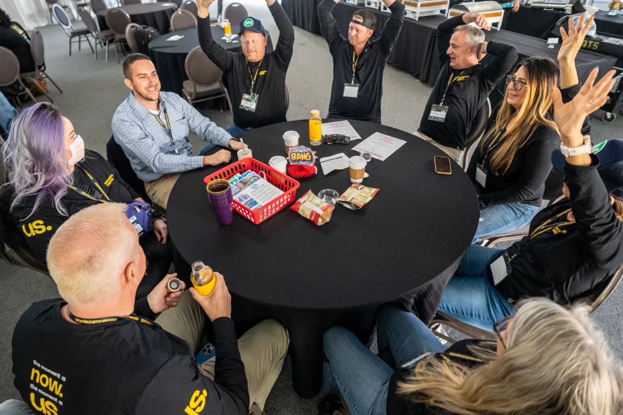 Employees enjoy a game during the company's all-staff meeting.