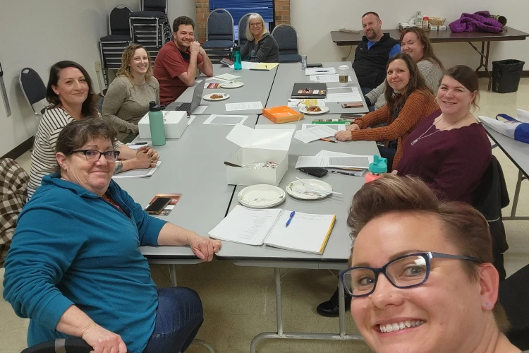Members of Emma's Cooperative Corp. and Education Fund, one of Capital Impact Partner's Co-op Innovation 2024 Award winners, pose together around a table.