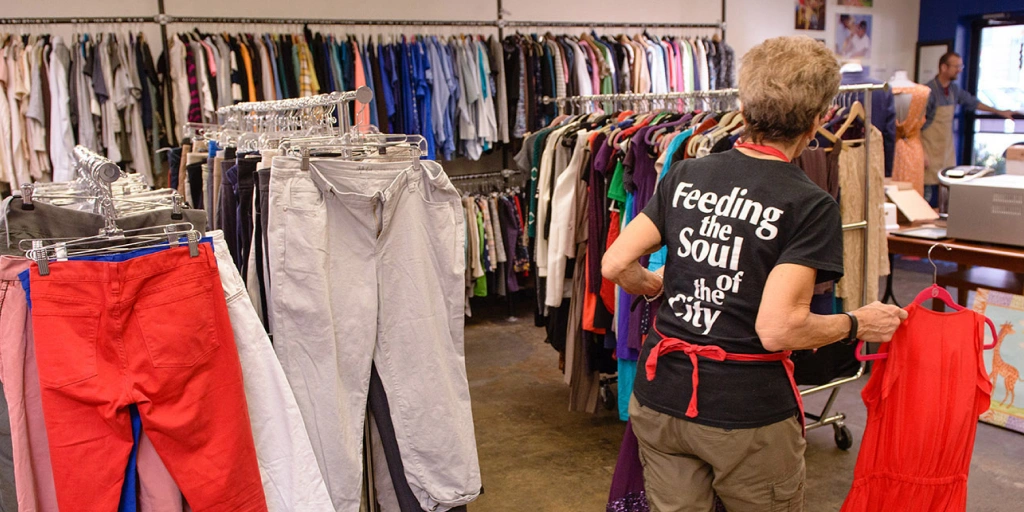 A Martha's Table volunteer stocks clothes at the organization's distribution center.