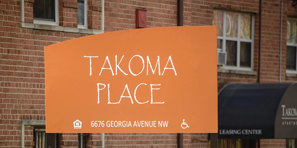 Exterior sign of the Takoma Place apartments.
