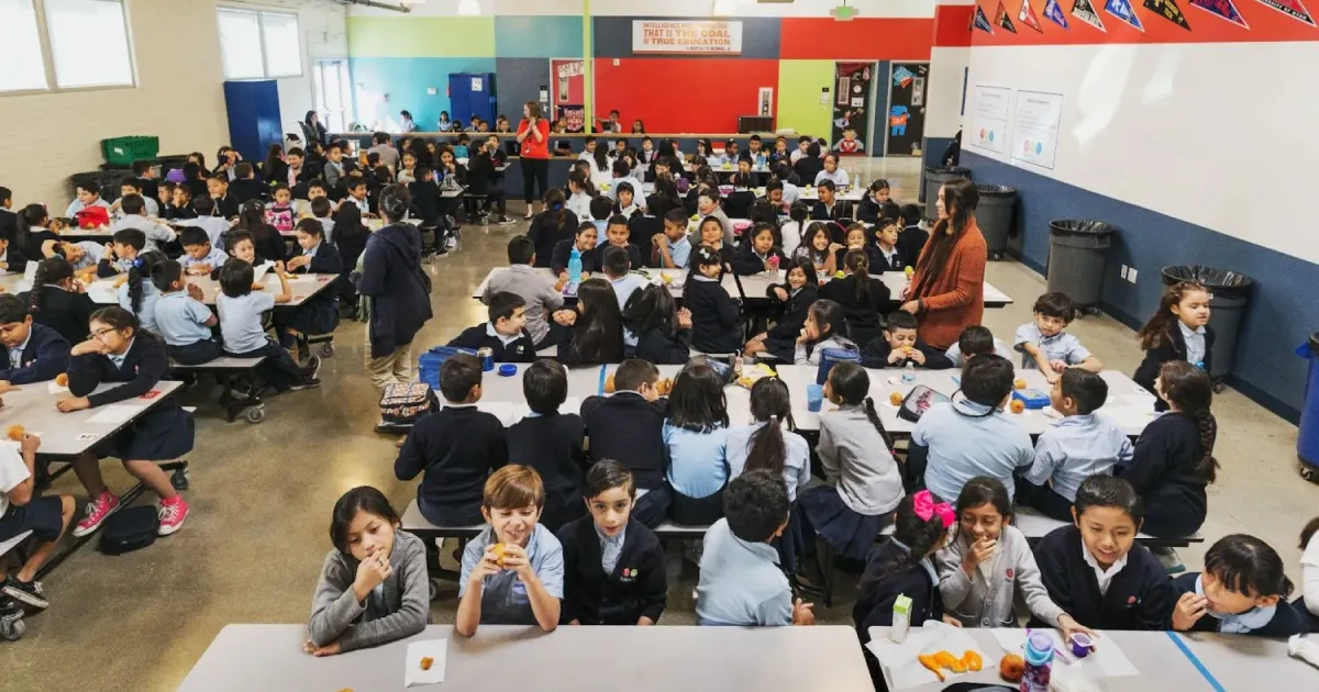 Students sitting at a charter school cafeteria that received financing from Capital Impact Partners