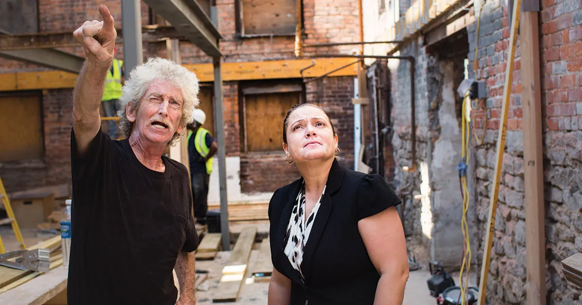 Landy and Capital Impact Partners’ Senior Loan Officer, and Detroit native, Melinda Clemons, stand inside a construction site that Capital Impact Partners' helped to provide lending for.
