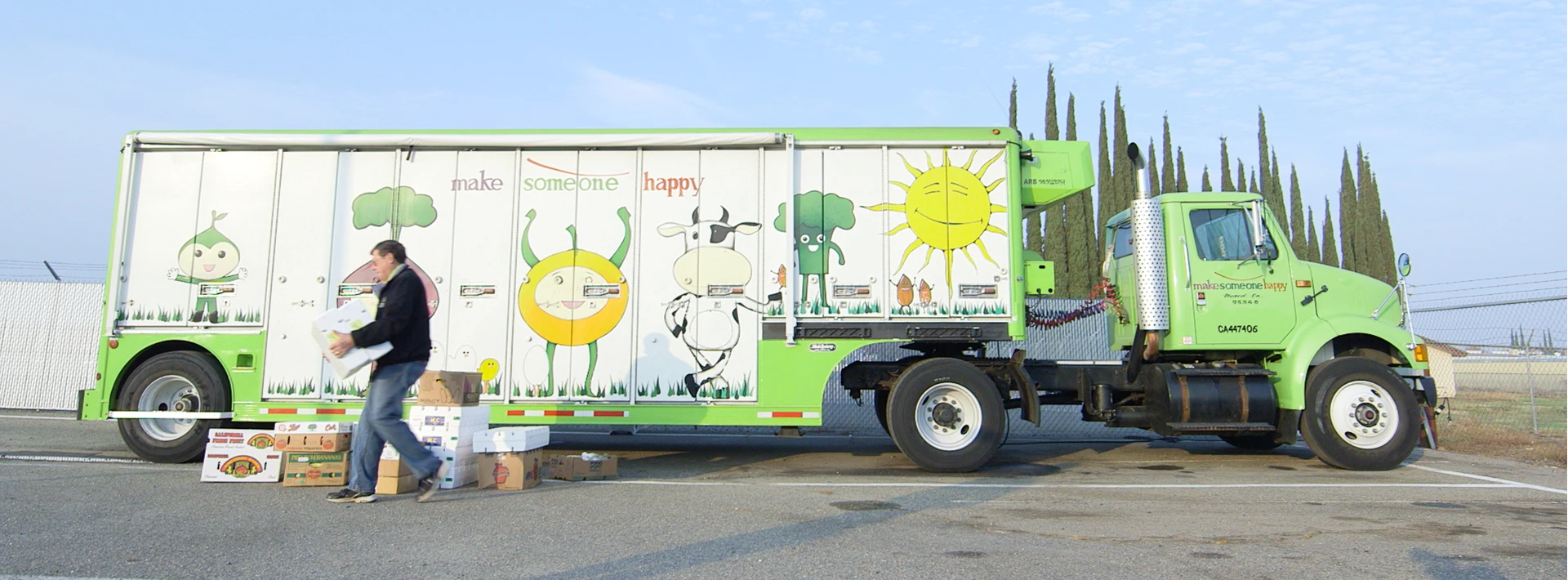 View of the exterior of a big green truck, also known as the Produce on the Go mobile farmers market, which travels throughout food deserts in northern California, made possible with lending from Capital Impact Partners.