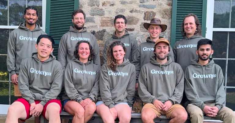Members of Farm Generations Cooperative, a Capital Impact Partners 2025 Co-op Innovation Award winner, pose together in sweatshirts that say "Grown By", the name of their farm sales platform.
