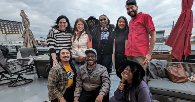 Board members of the U.S. Federation of Worker Cooperatives pose on a rooftop, celebrating their mission to enhance worker ownership and child care through the Capital Impact Partners 2025 Co-op Innovation Award.