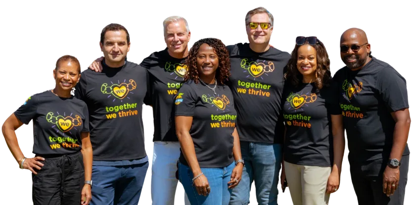 The Momentus Capital Executive Management team gathers together at the 2025 company all staff event, all wearing the same t-shirt and smiling.