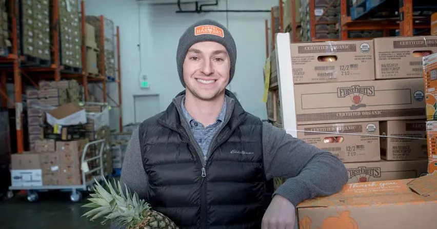 Hungry Harvest CEO Evan Lutz walking through the warehouse supported by growth capital from Momentus Capital.