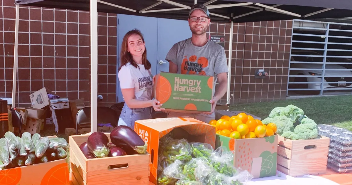 Team members packing HarvestRx produce boxes for Food as Medicine programs and healthy food delivery.