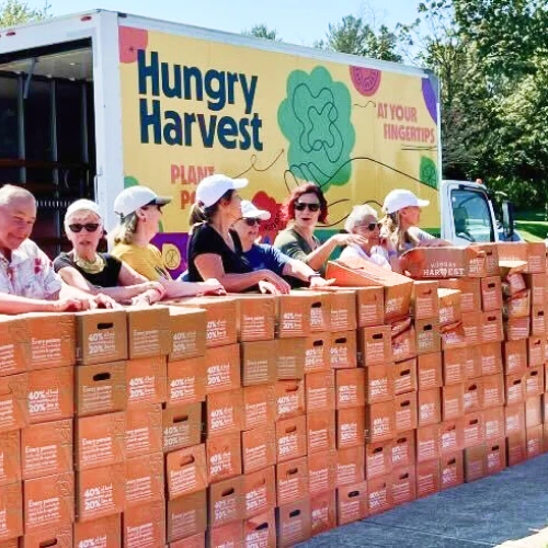 Hungry Harvest warehouse team organizing produce boxes at scale supported by mezzanine financing from Momentus Capital.